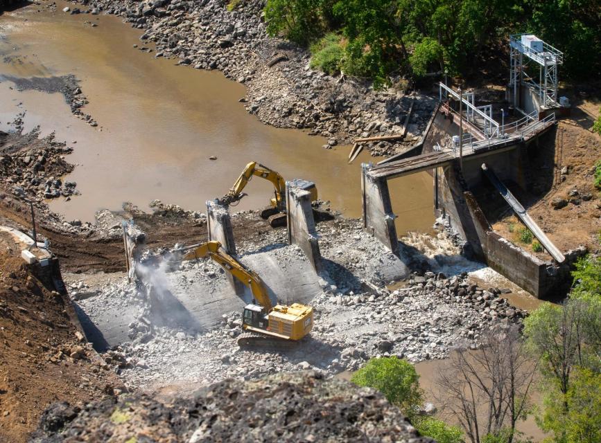 Photo of heavy machinery tearing down Copco No. 2 power dam on the Klamath River in July 2023